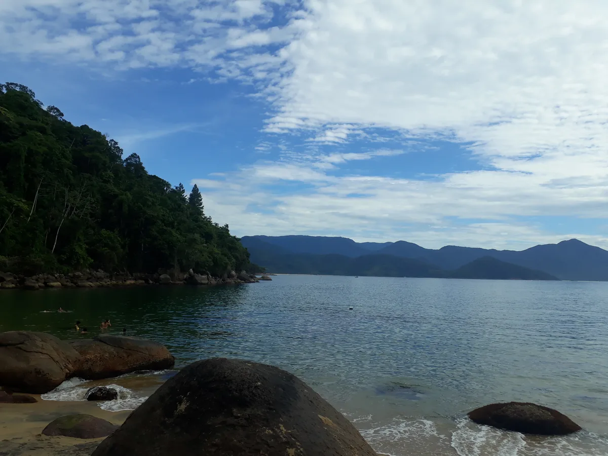 Praia do Cedro em Ubatuba com mar calmo e transparente, areia clara e Mata Atlântica preservada ao redor